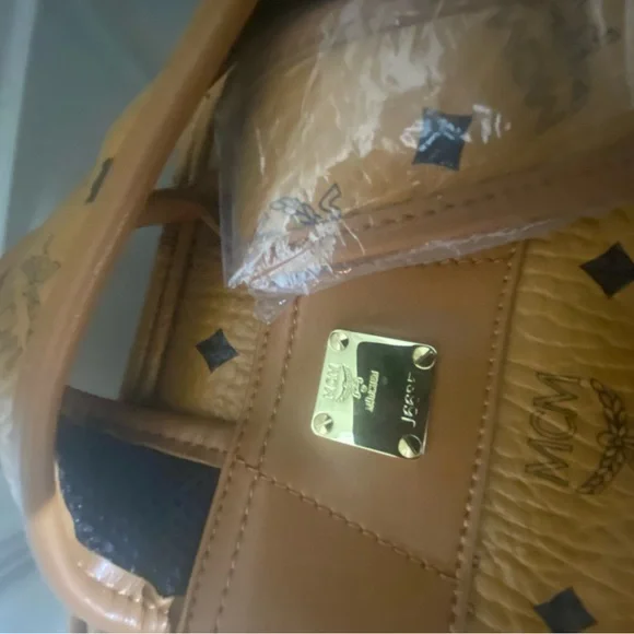 MCM small Cognac back pack with storage bag.